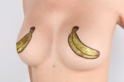 Model Image - Banana Glitter Pasties applied to bust of female model